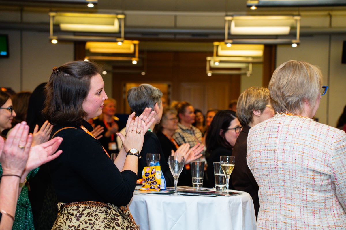 Audience responding to speakers at women leaders event